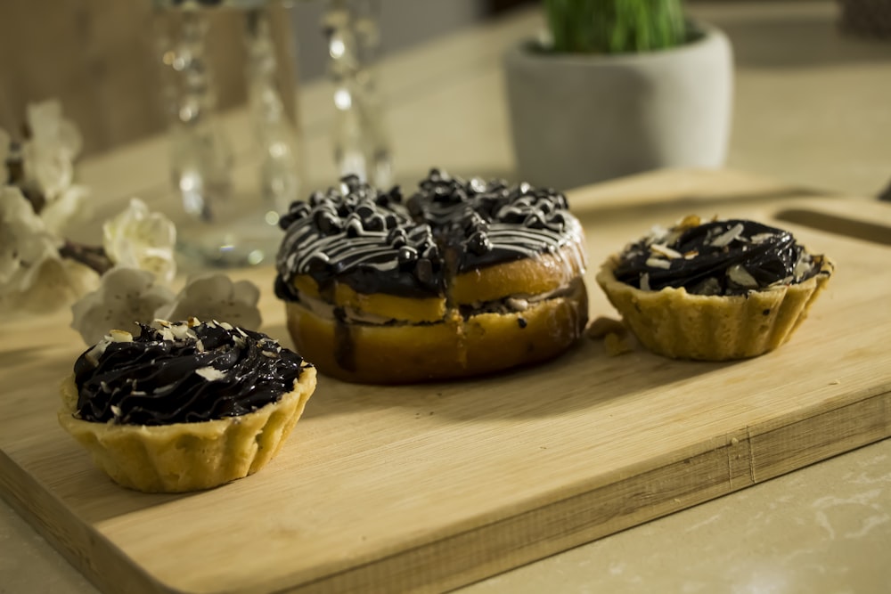 black and white chocolate cupcakes on brown wooden tray