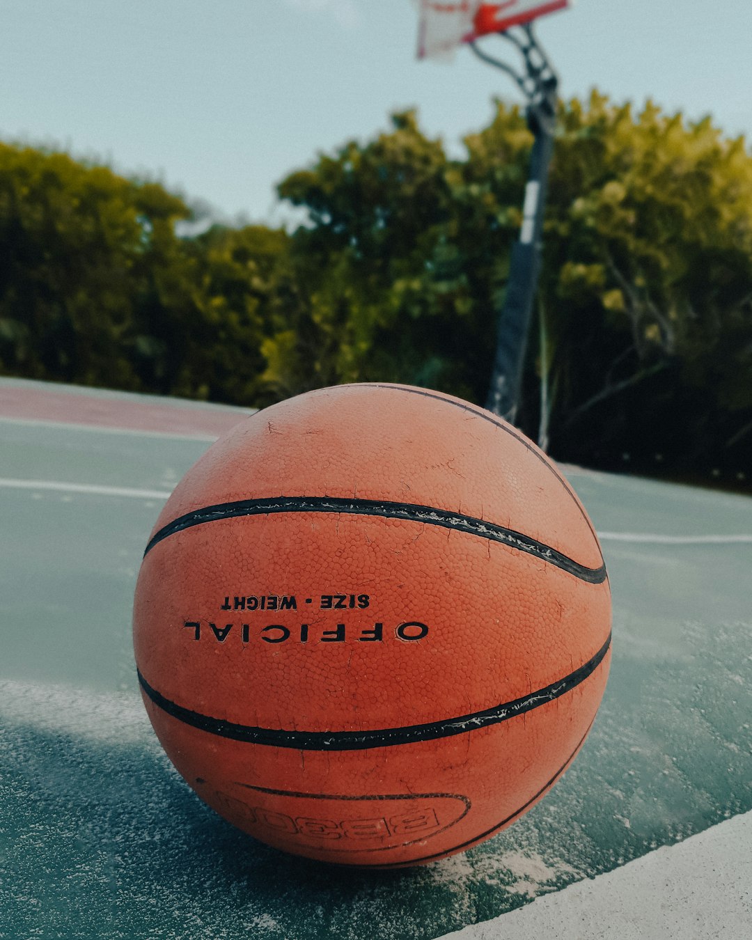 orange basketball on gray asphalt road during daytime