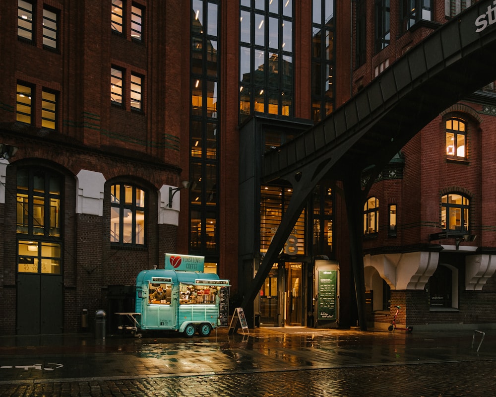 green bus on road near building during daytime