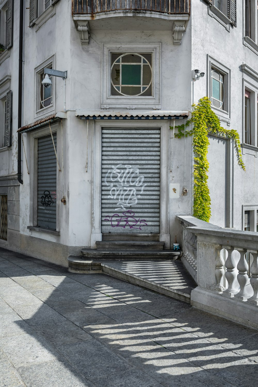 white wooden door on white concrete building