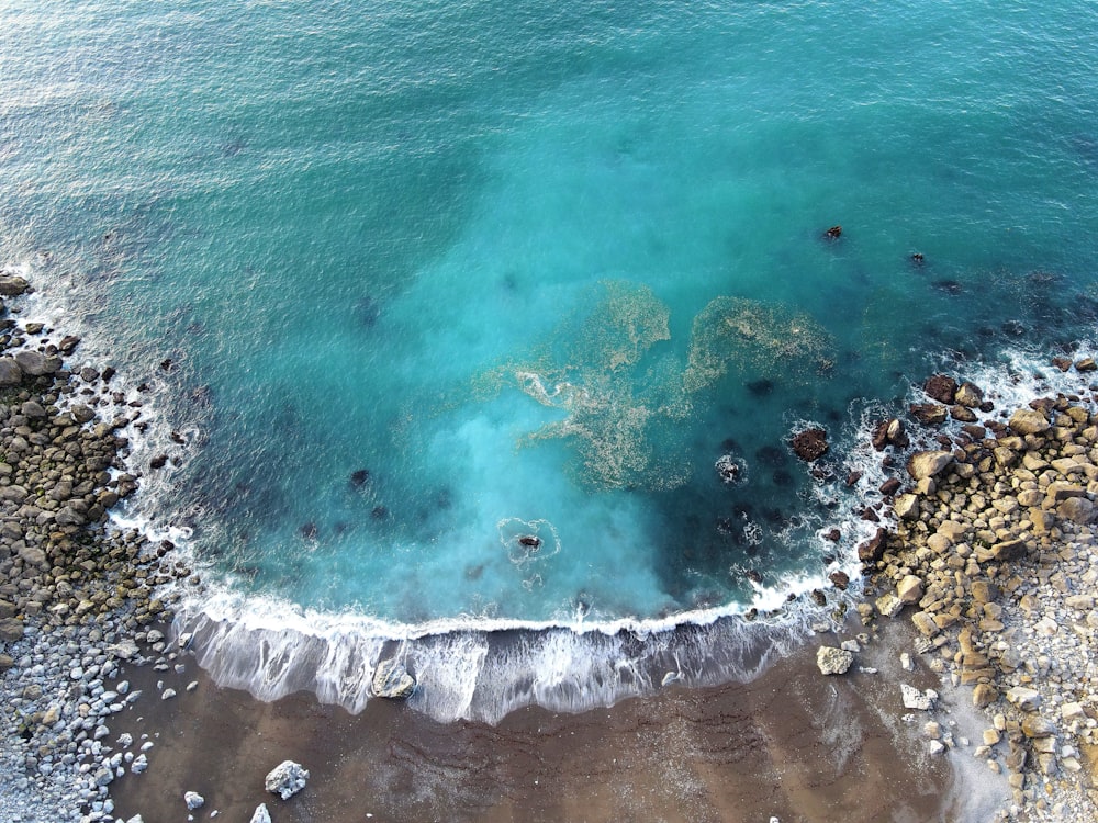 aerial view of ocean waves on shore during daytime