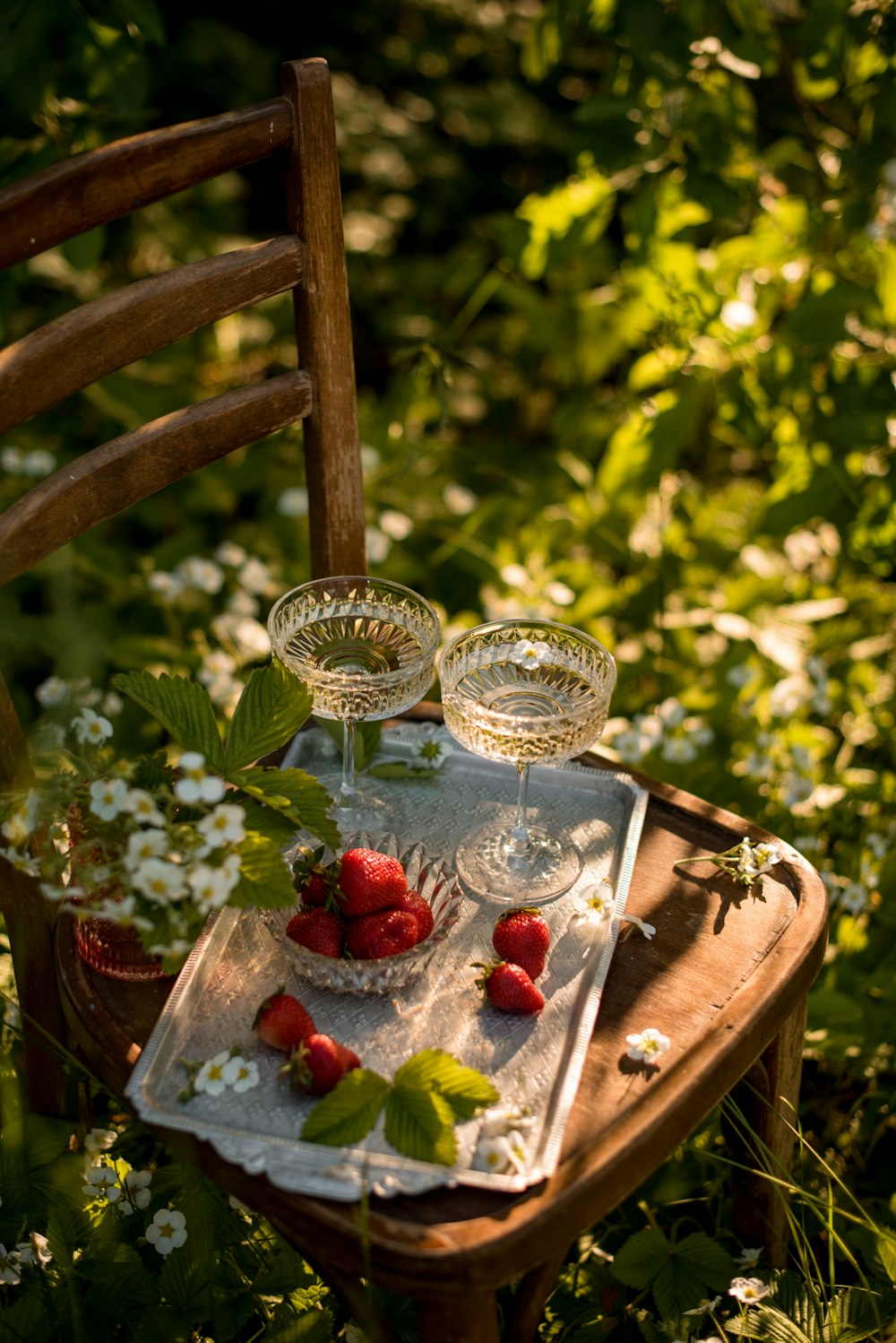 clear glass bowl with red and white berries on brown wooden table
