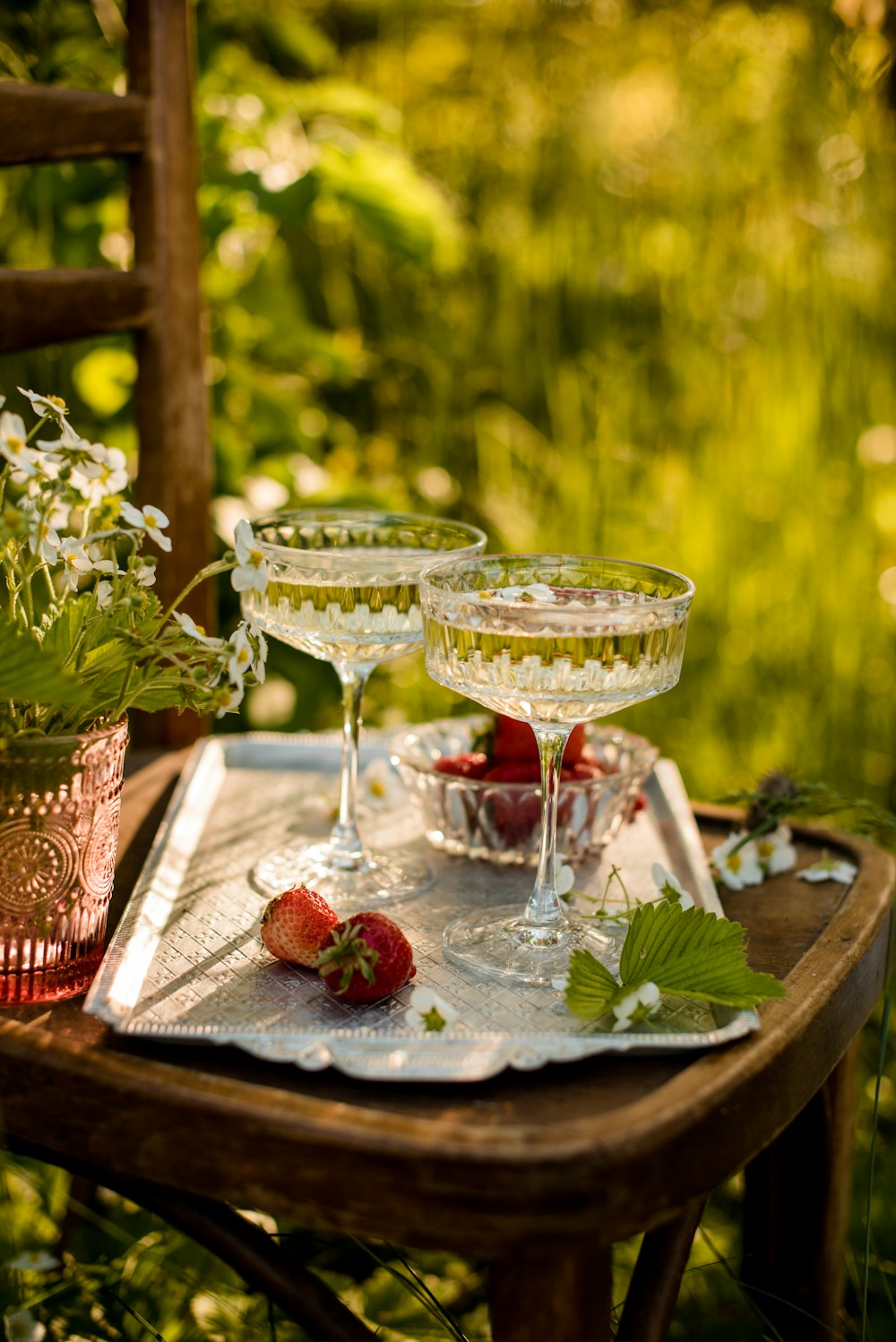 two clear wine glasses on red and white table cloth