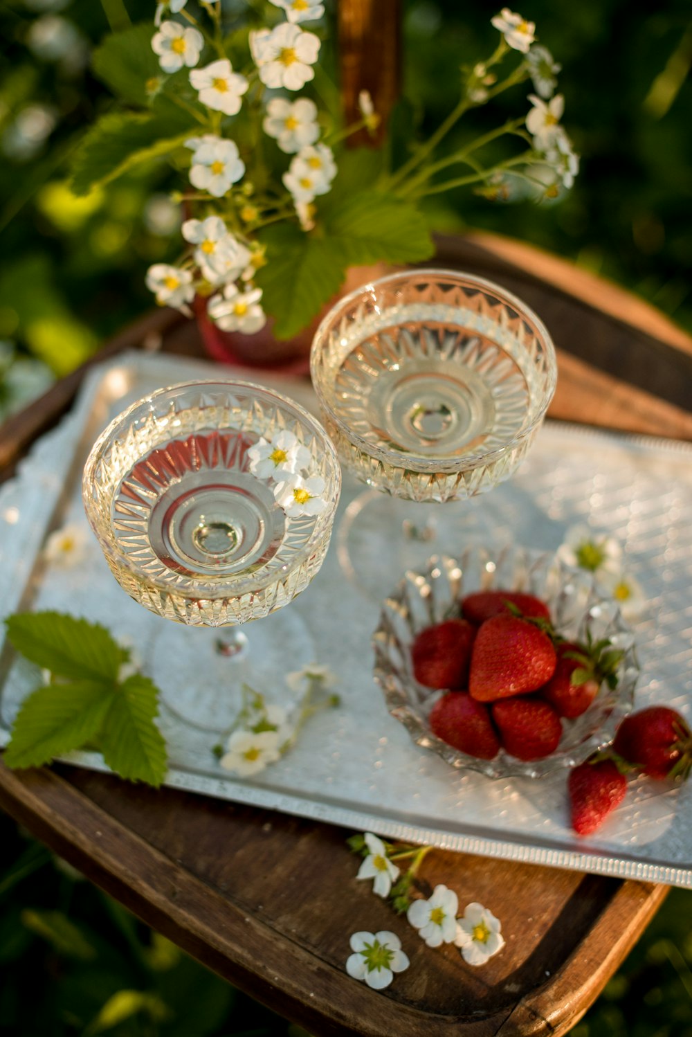 three white and red ceramic floral bowls on blue wooden table