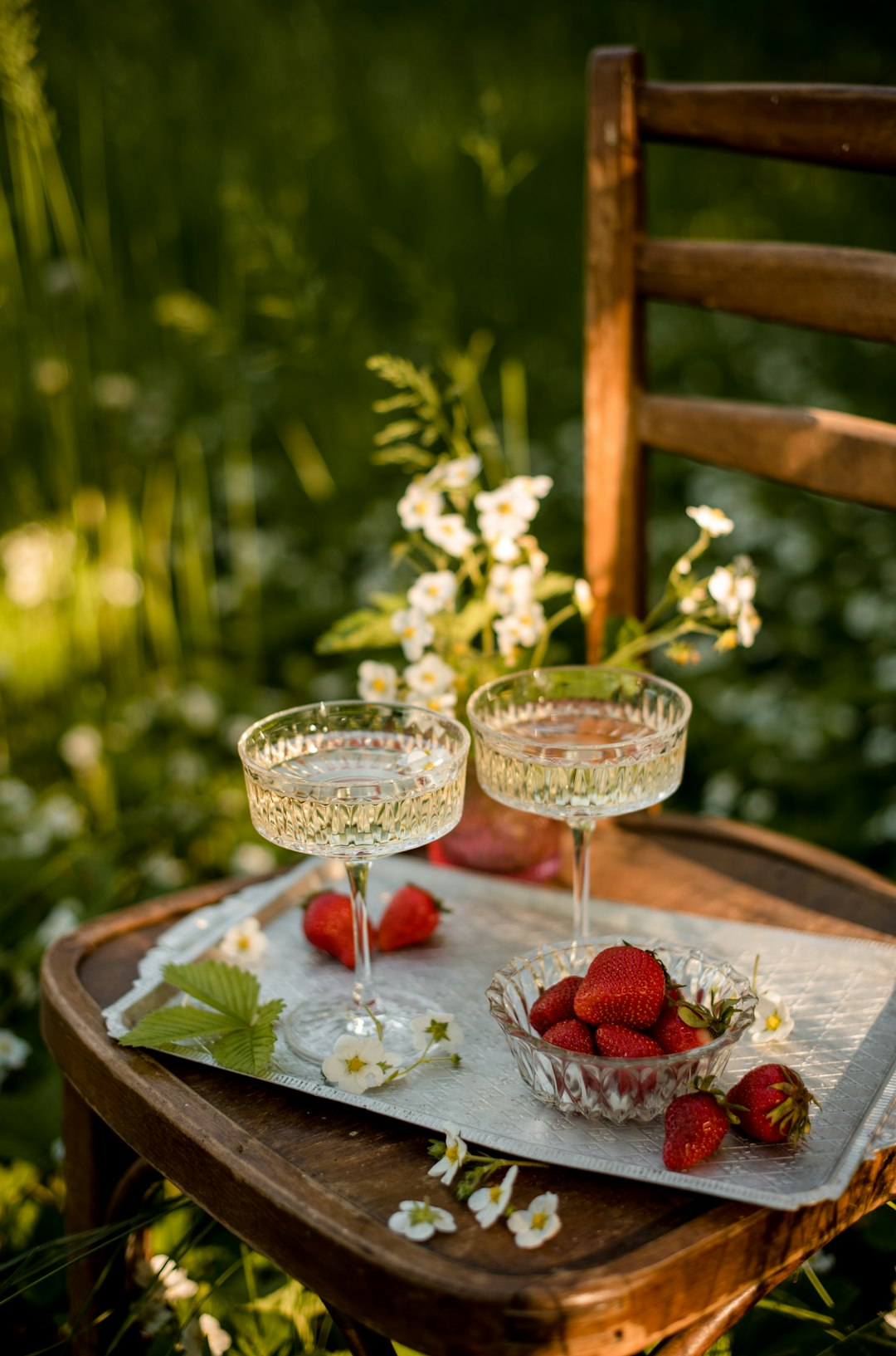 two clear wine glasses on brown wooden table