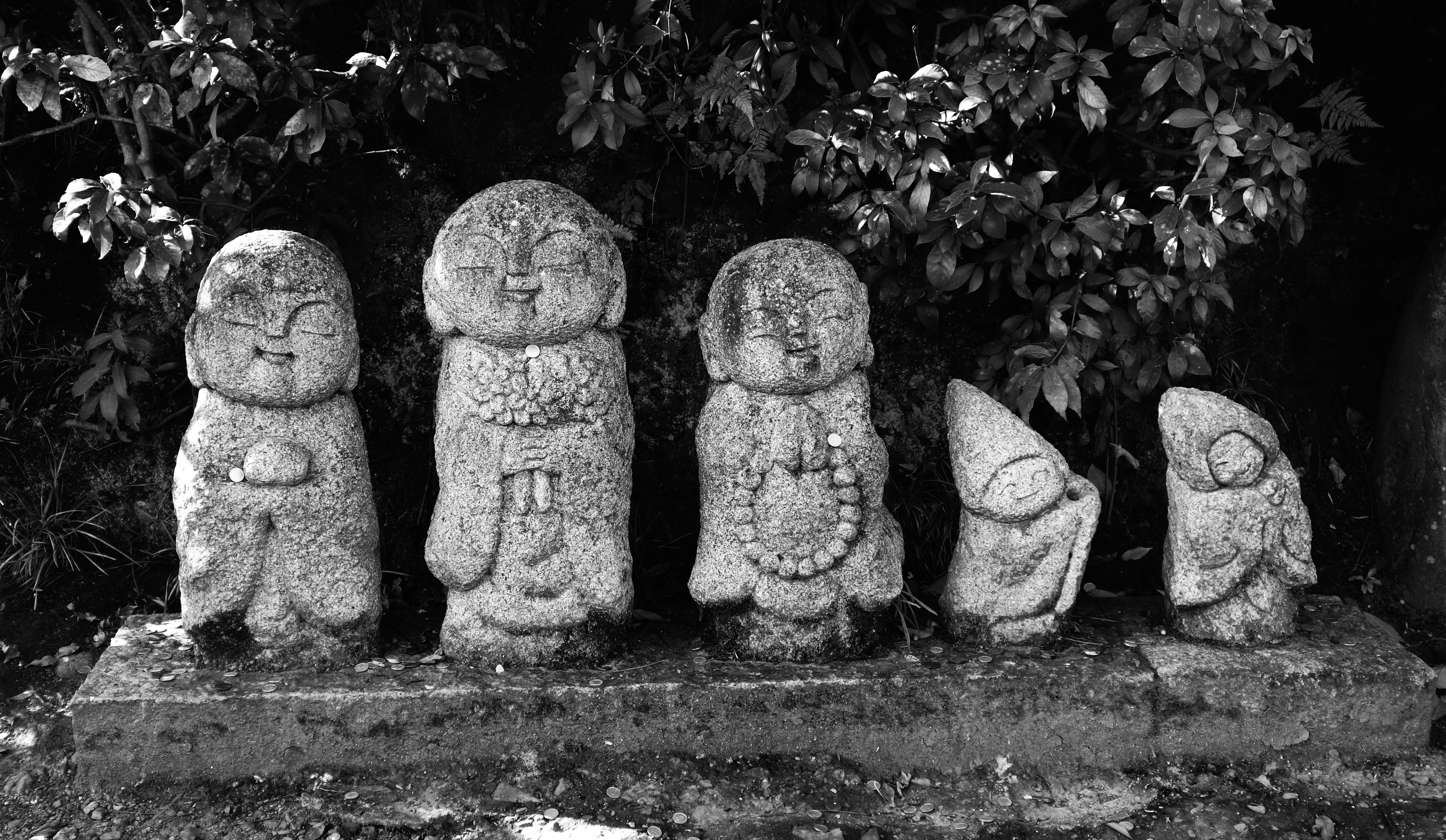 gray concrete statue on grass field