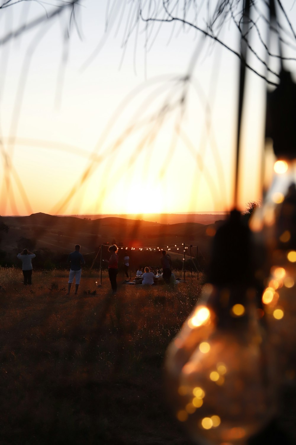 people standing on brown sand during sunset