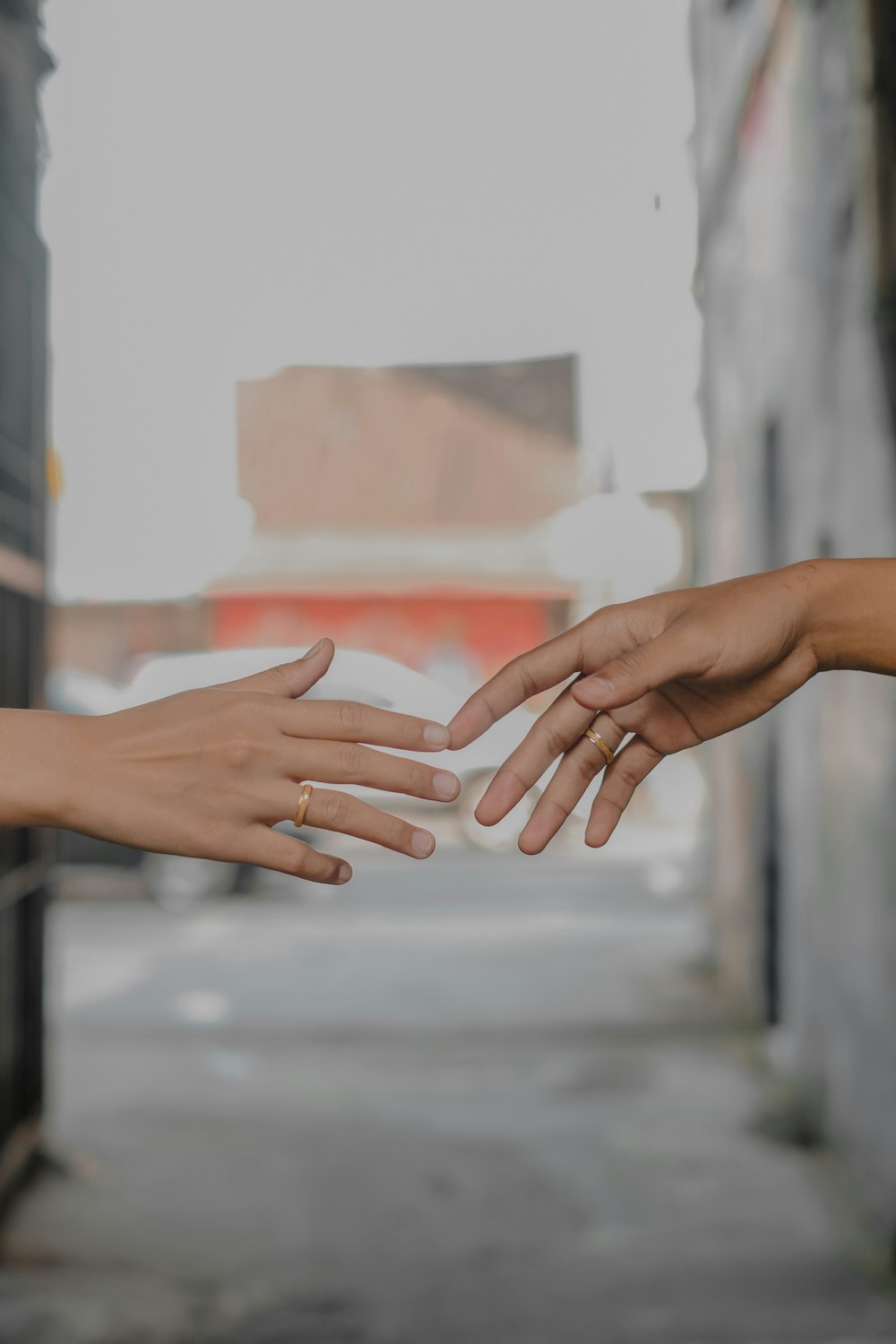 persons hand with white nail polish