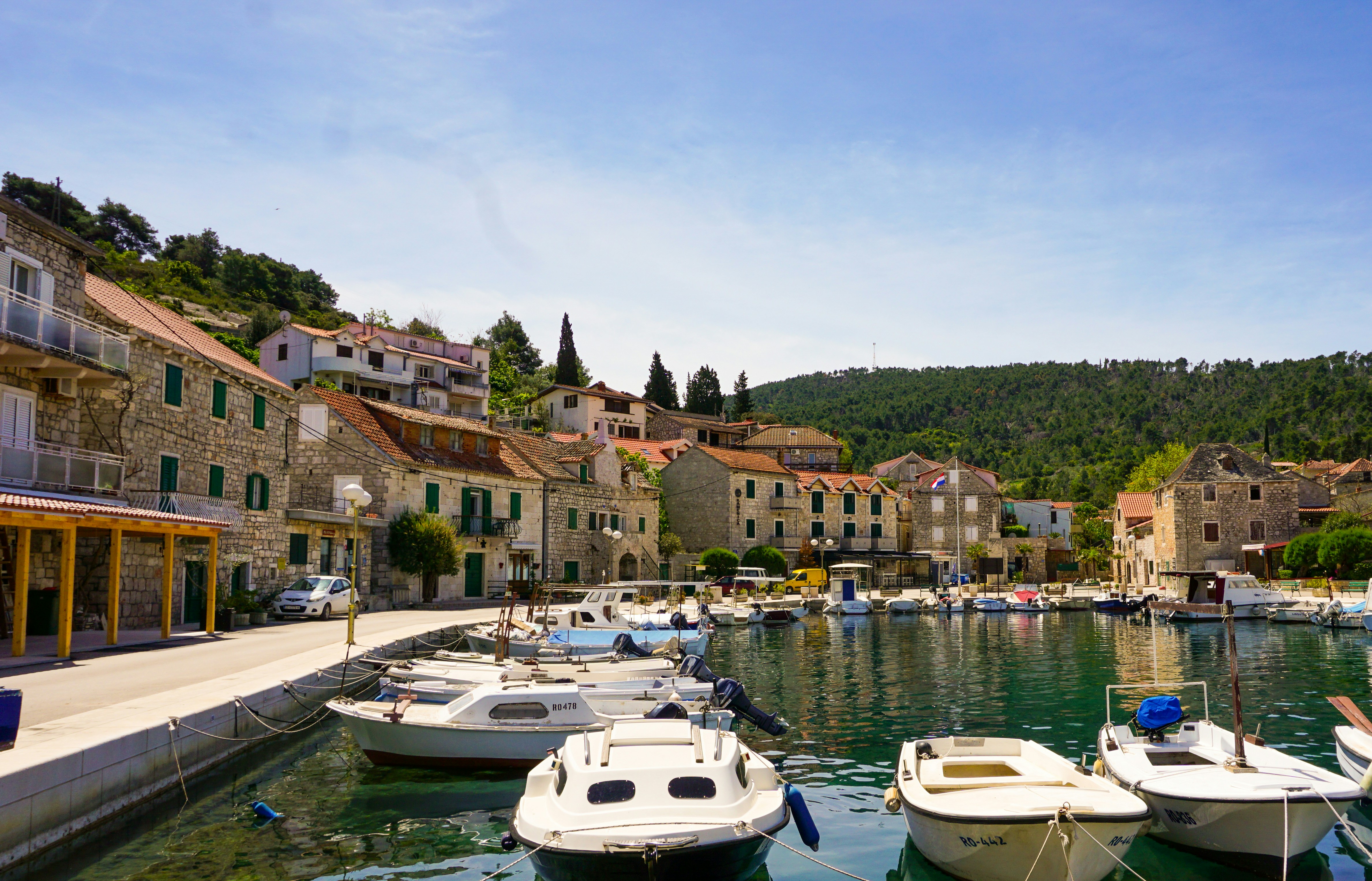 White boat on river near houses during daytime
