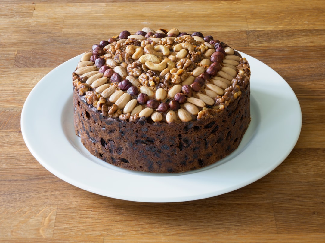 brown cake with white icing on white ceramic plate