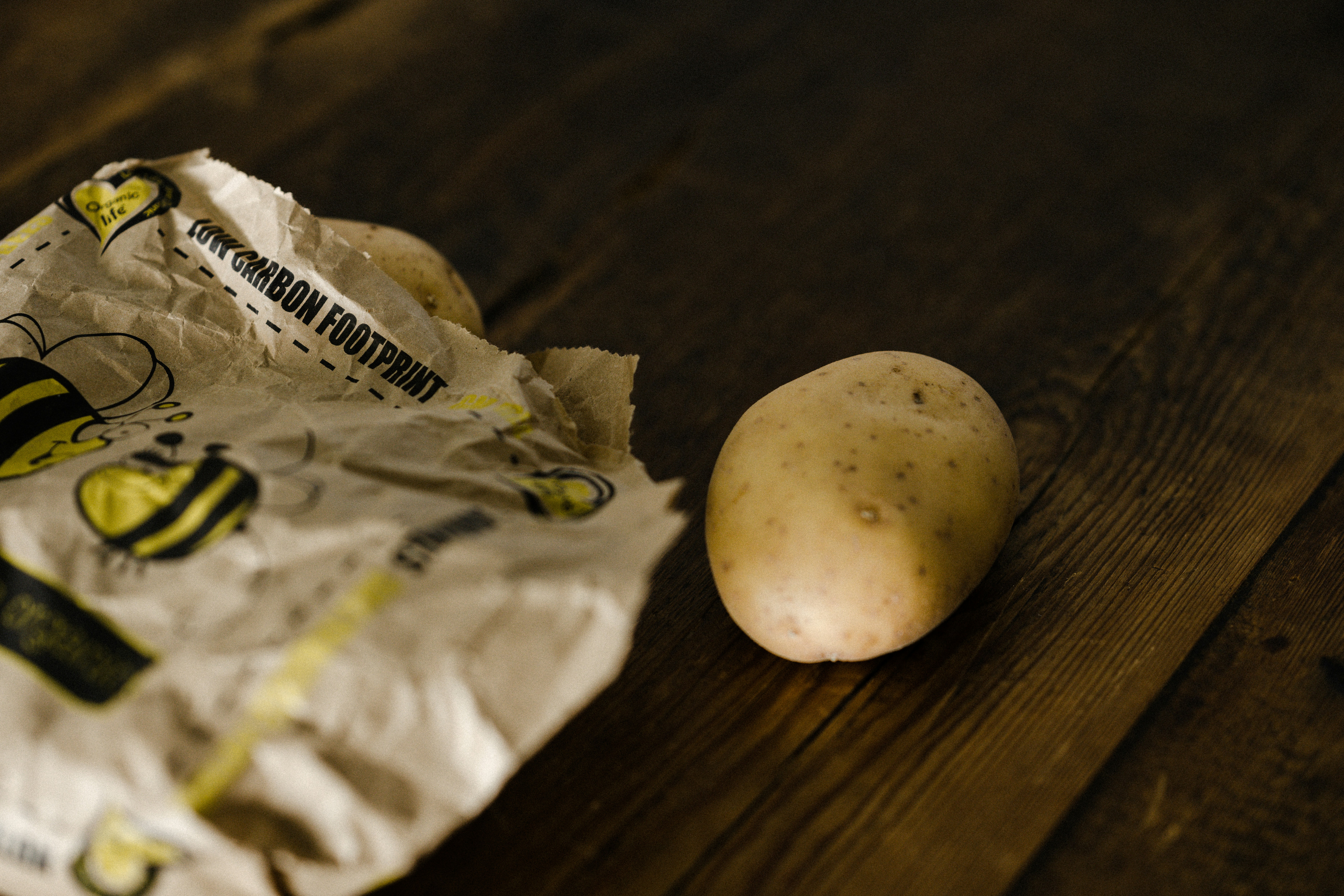 A grandmother holding a freshly dug potato, showing it to her grandson.