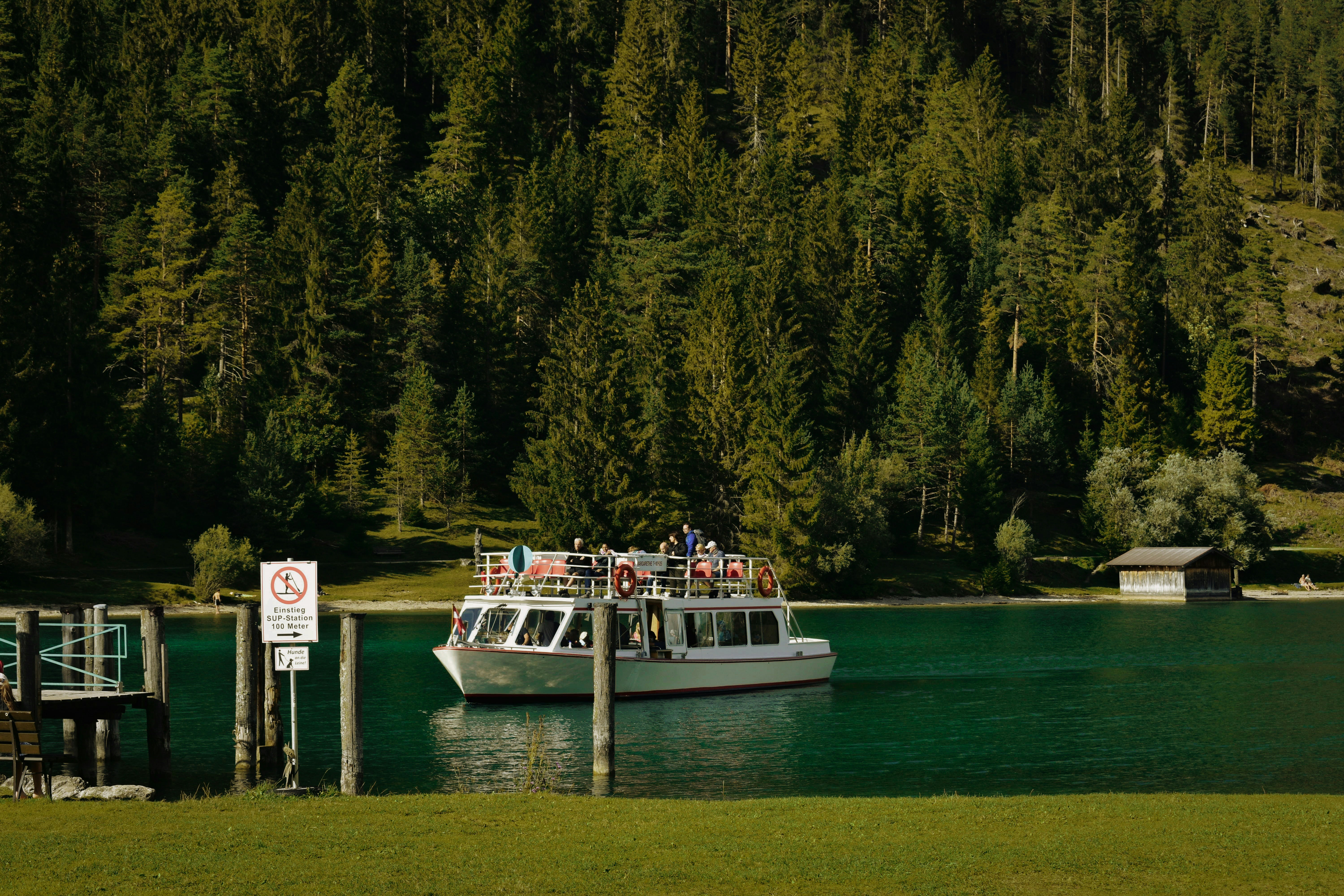 white and blue boat on body of water during daytime