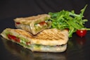 sandwich with vegetable on brown wooden table