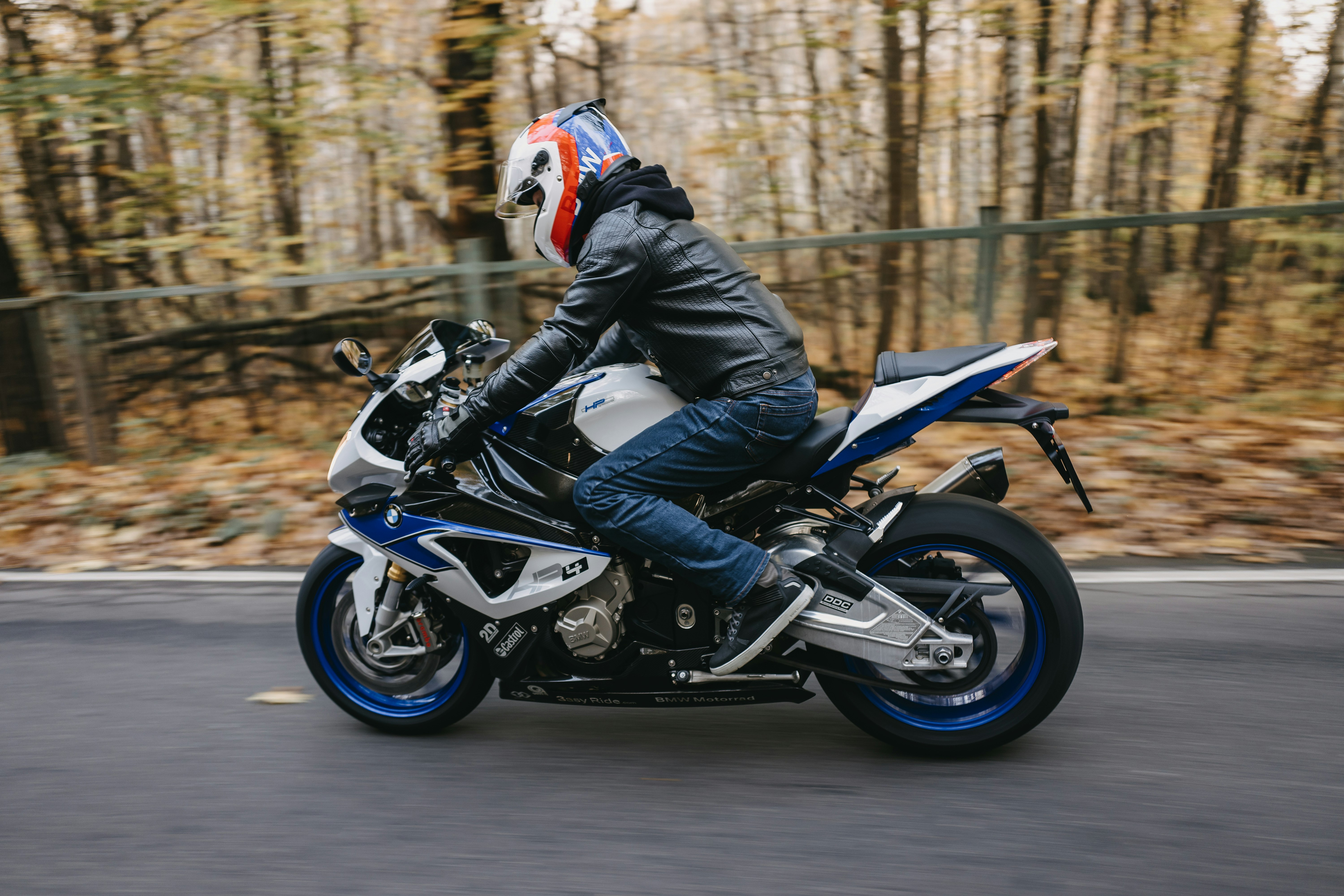 man in blue and white motorcycle suit riding on black and blue sports bike