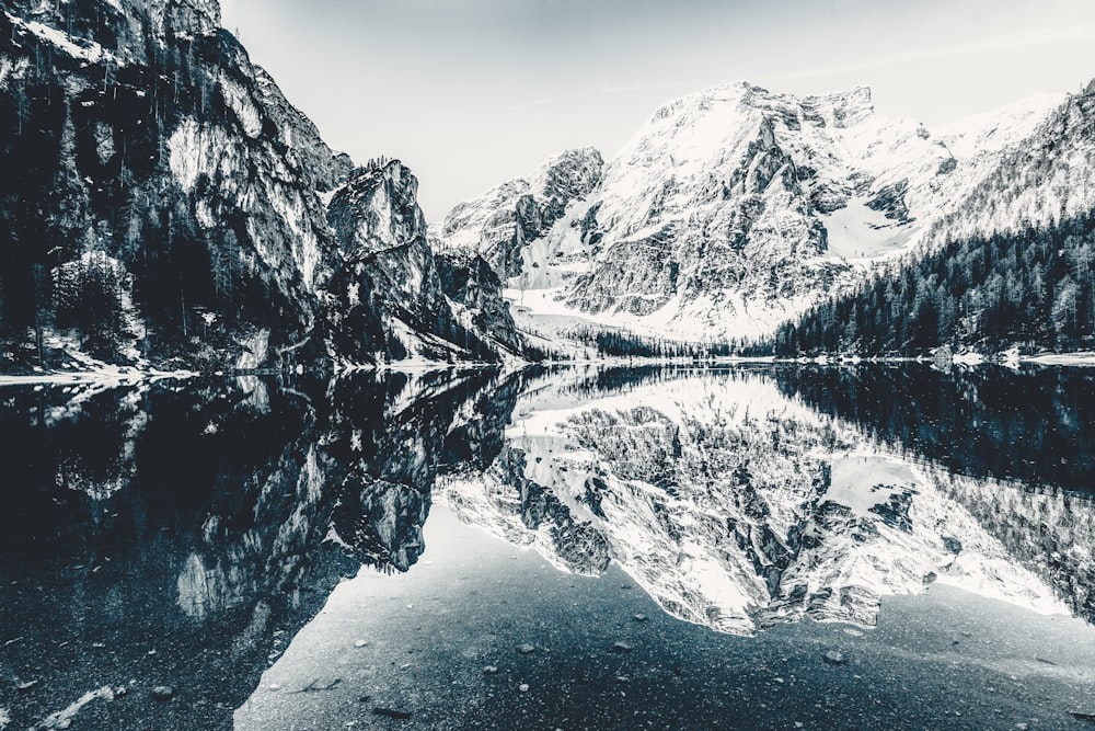 snow covered mountain near lake