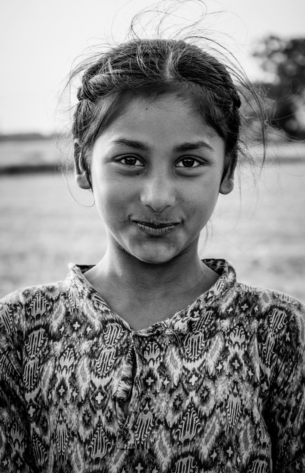 grayscale photo of woman in floral shirt