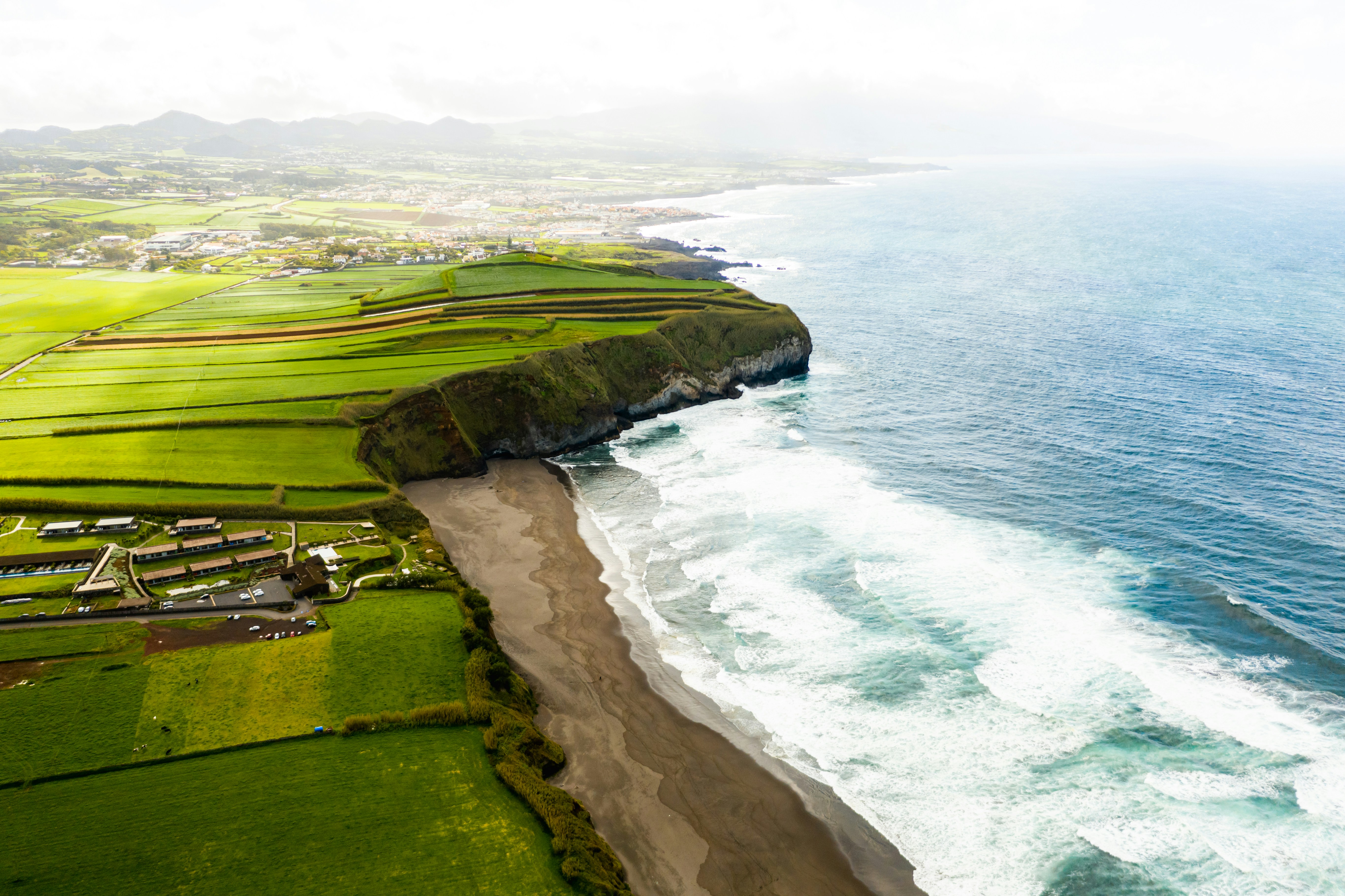 green grass field near body of water during daytime
