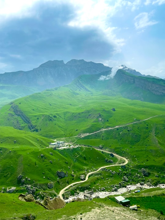 green mountains under blue sky during daytime in Laza Azerbaijan