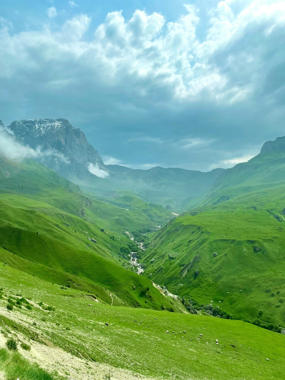 green mountains under white clouds during daytime