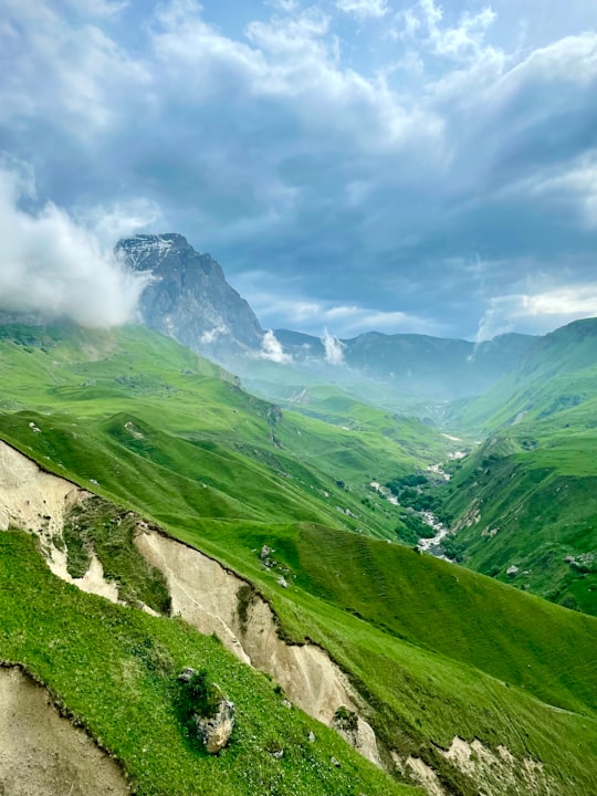 green grass covered mountain under cloudy sky during daytime in Laza Azerbaijan