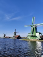windmill near body of water during daytime