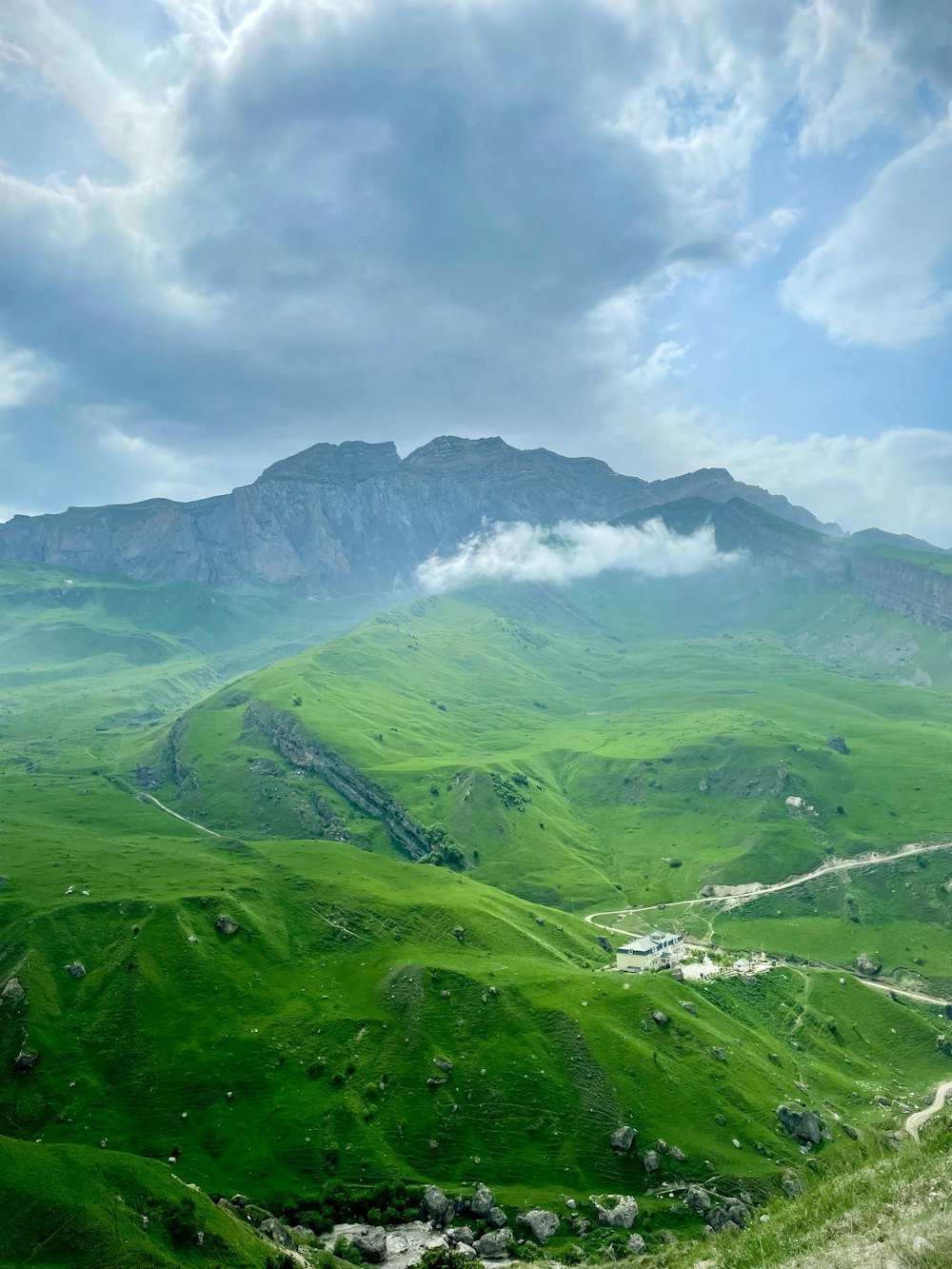 green mountains under white clouds during daytime