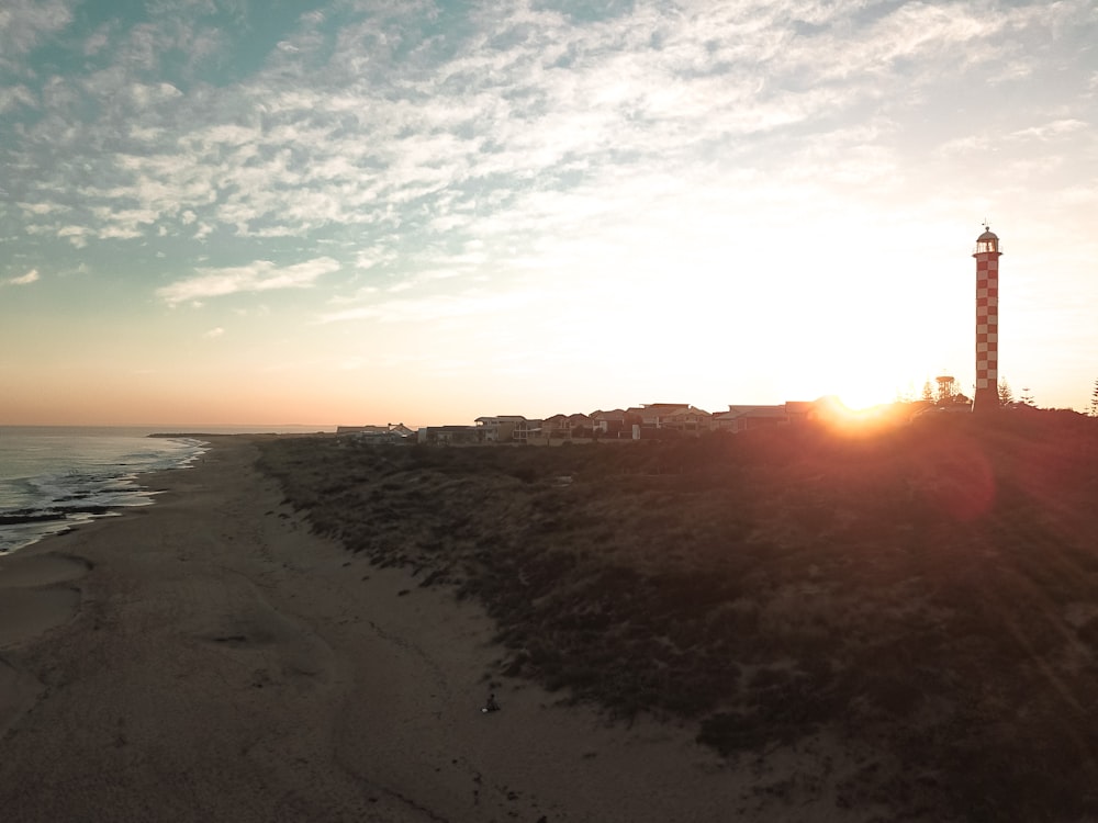 sea waves crashing on shore during sunset