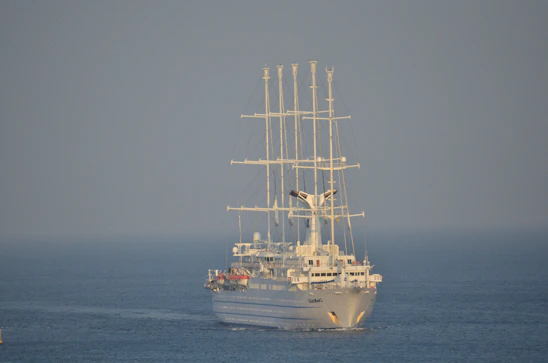 A sleek cargo vessel navigating calm blue seas under a clear sky, symbolizing modern marine operations.