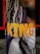 A vertical banner featuring a close-up image of a person with long dreadlocks and a gold chain around their neck. The word 'KING' is prominently displayed in bold, yellow letters across the image.
