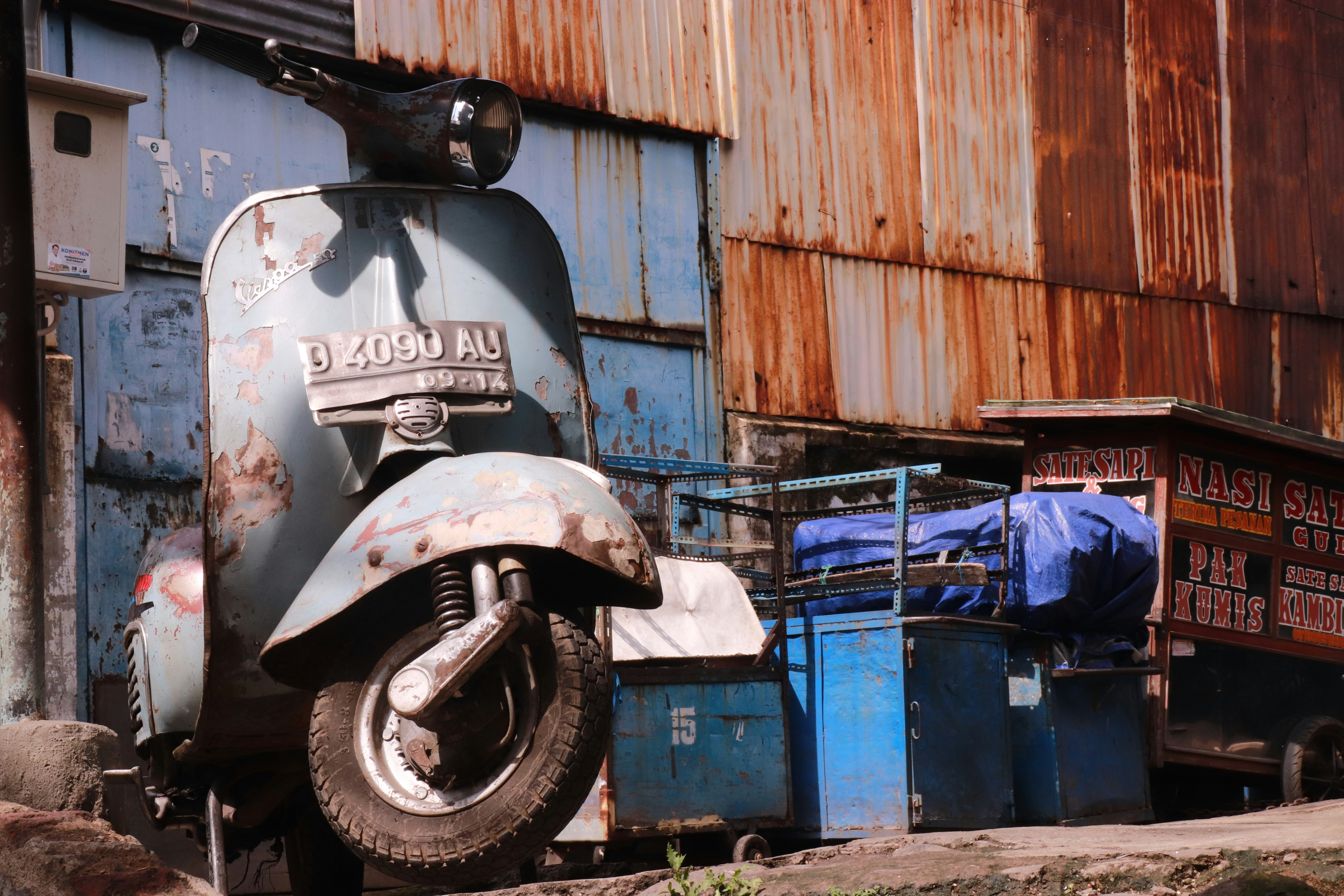 black and white motorcycle near blue plastic crate