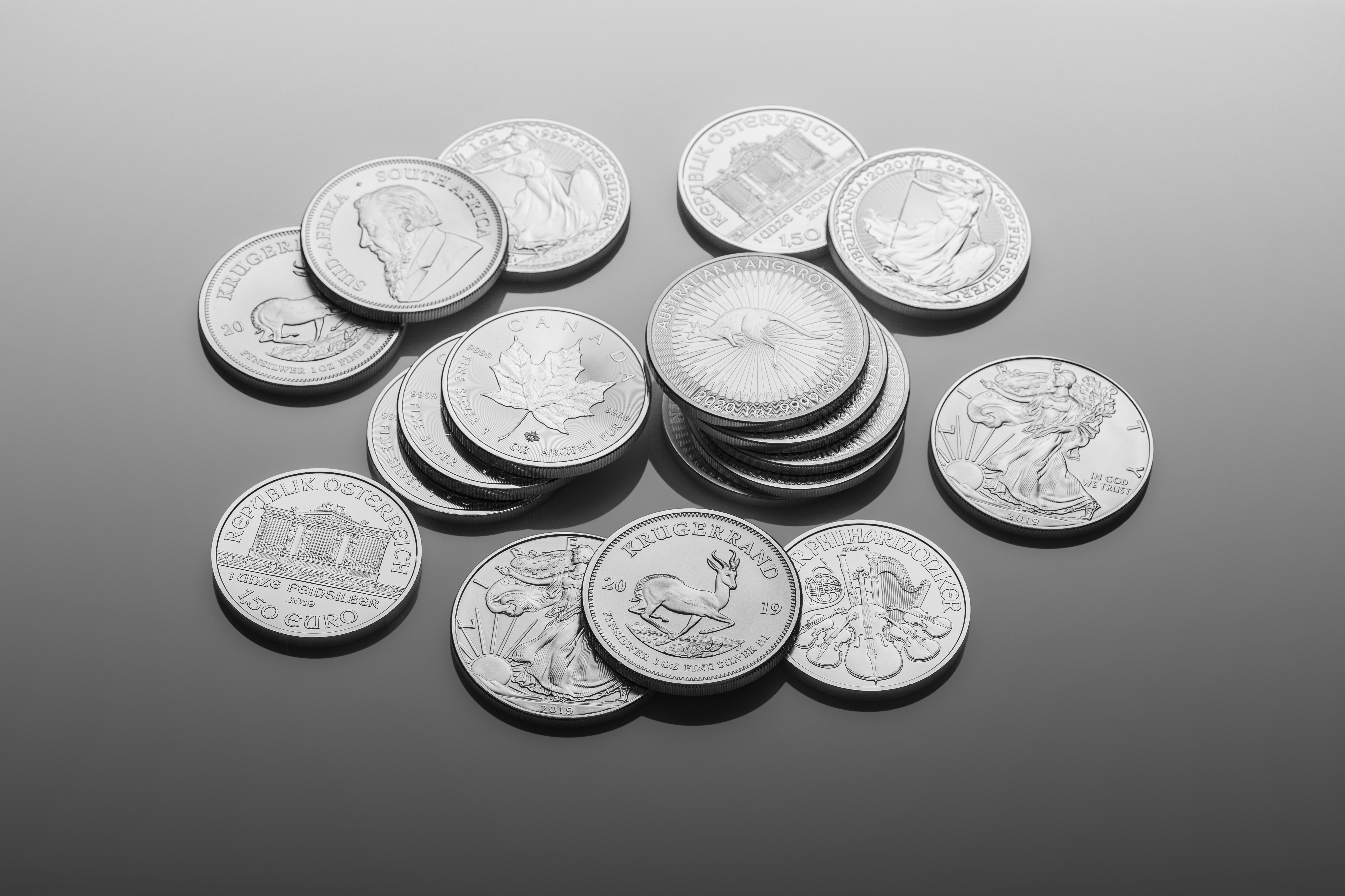 Pile of coins laid out on a shiny plate If you use our photos, please add credit to https://zlataky.cz, when possible