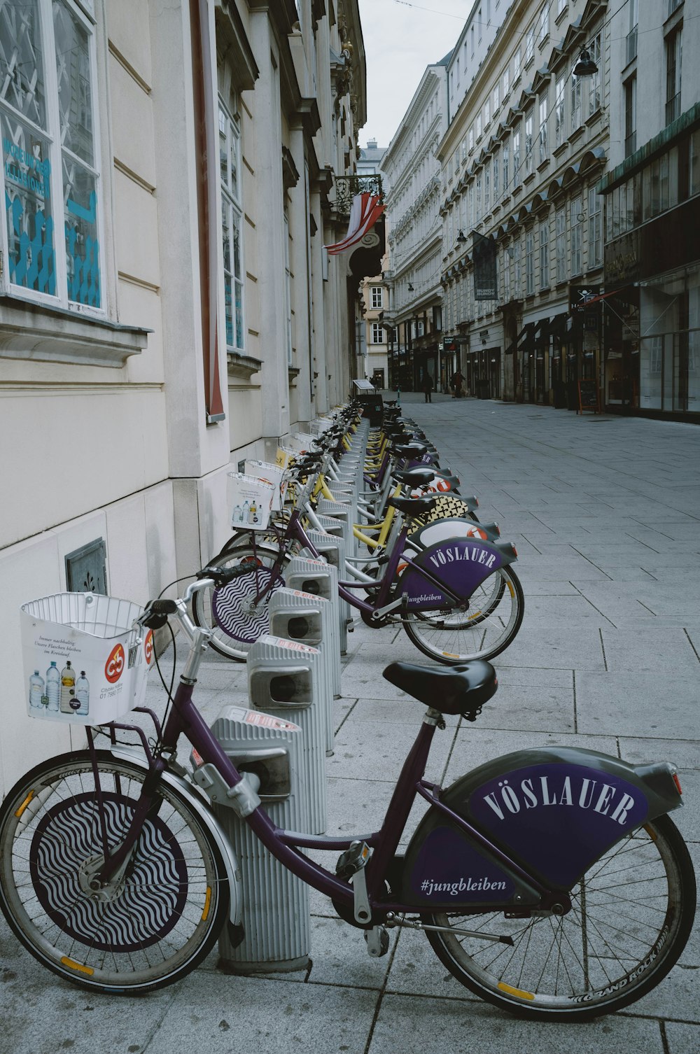 bicycles parked on sidewalk near building during daytime