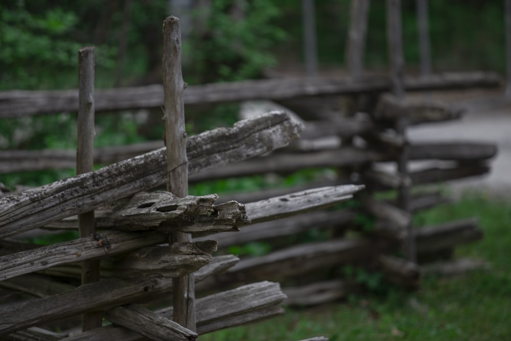 brown wooden fence on green grass field during daytime