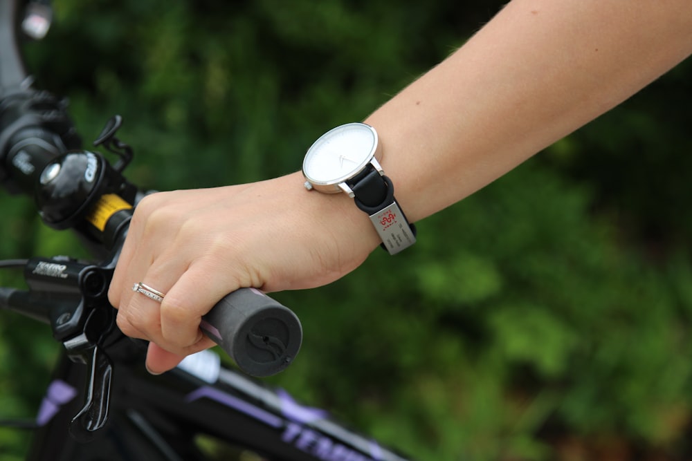 person holding black and white round device