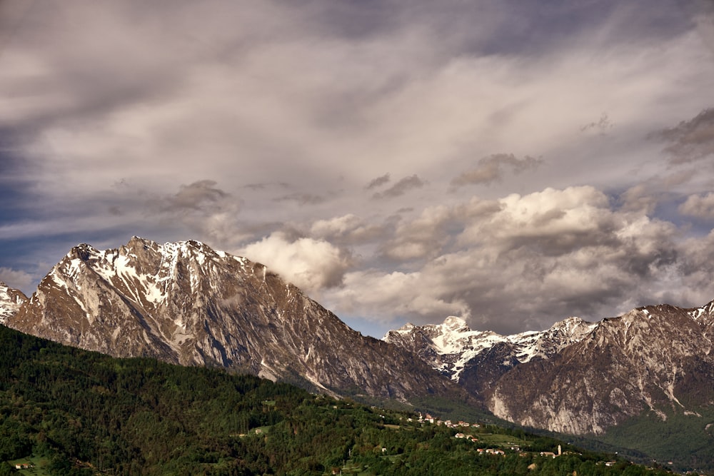 snow covered mountain under cloudy sky during daytime