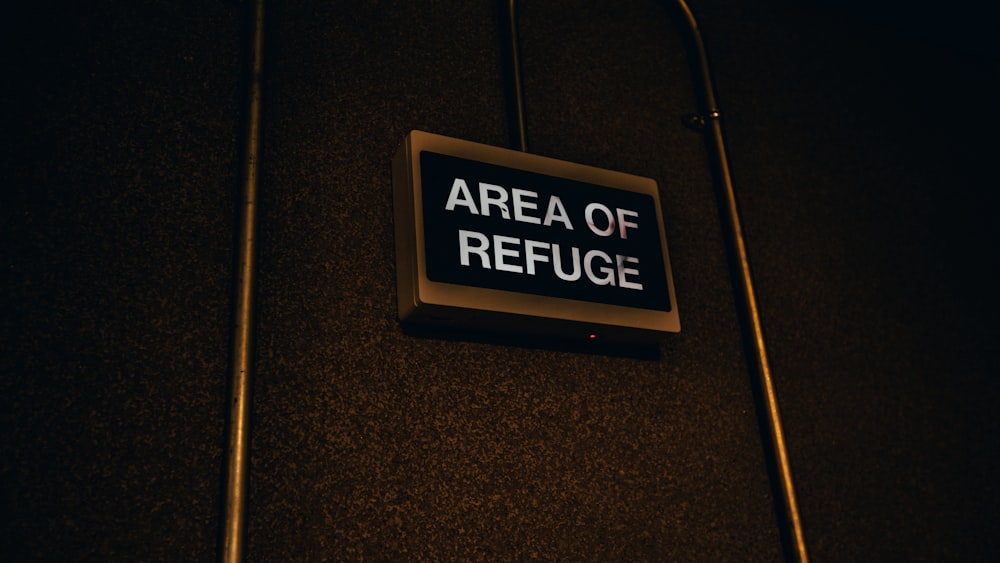 a sign on a wall that says area of refuge