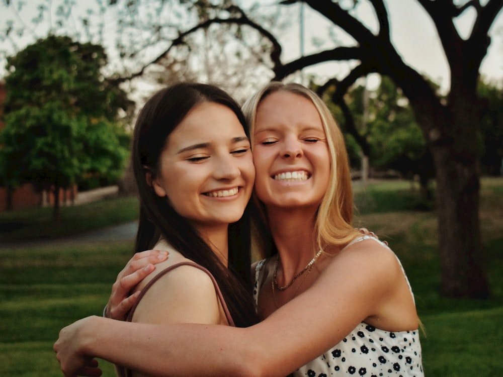 2 smiling women posing for photo