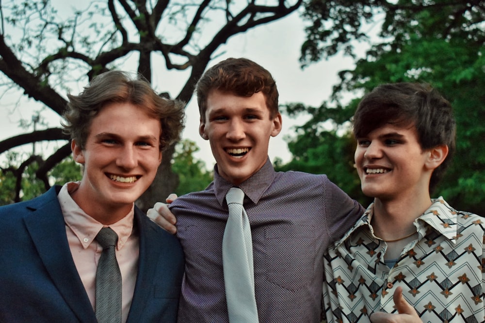 man in gray suit jacket smiling beside woman in gray and white plaid button up shirt