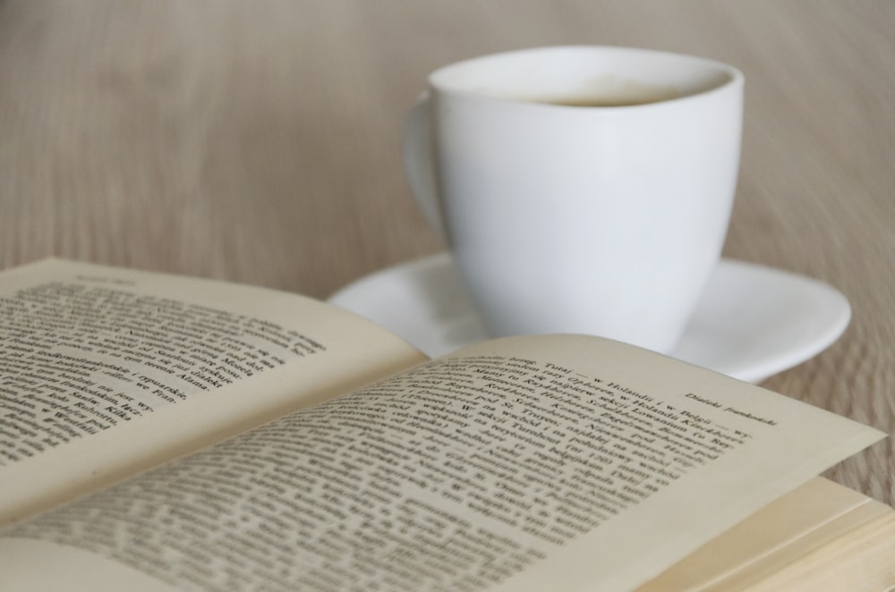 white ceramic mug on white book page