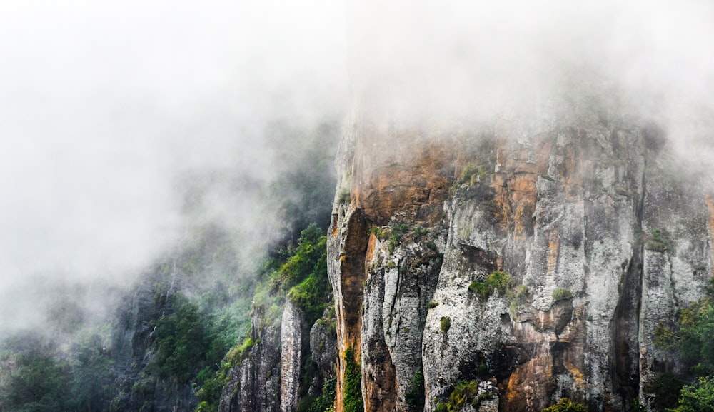 green and brown mountain under white clouds during daytime