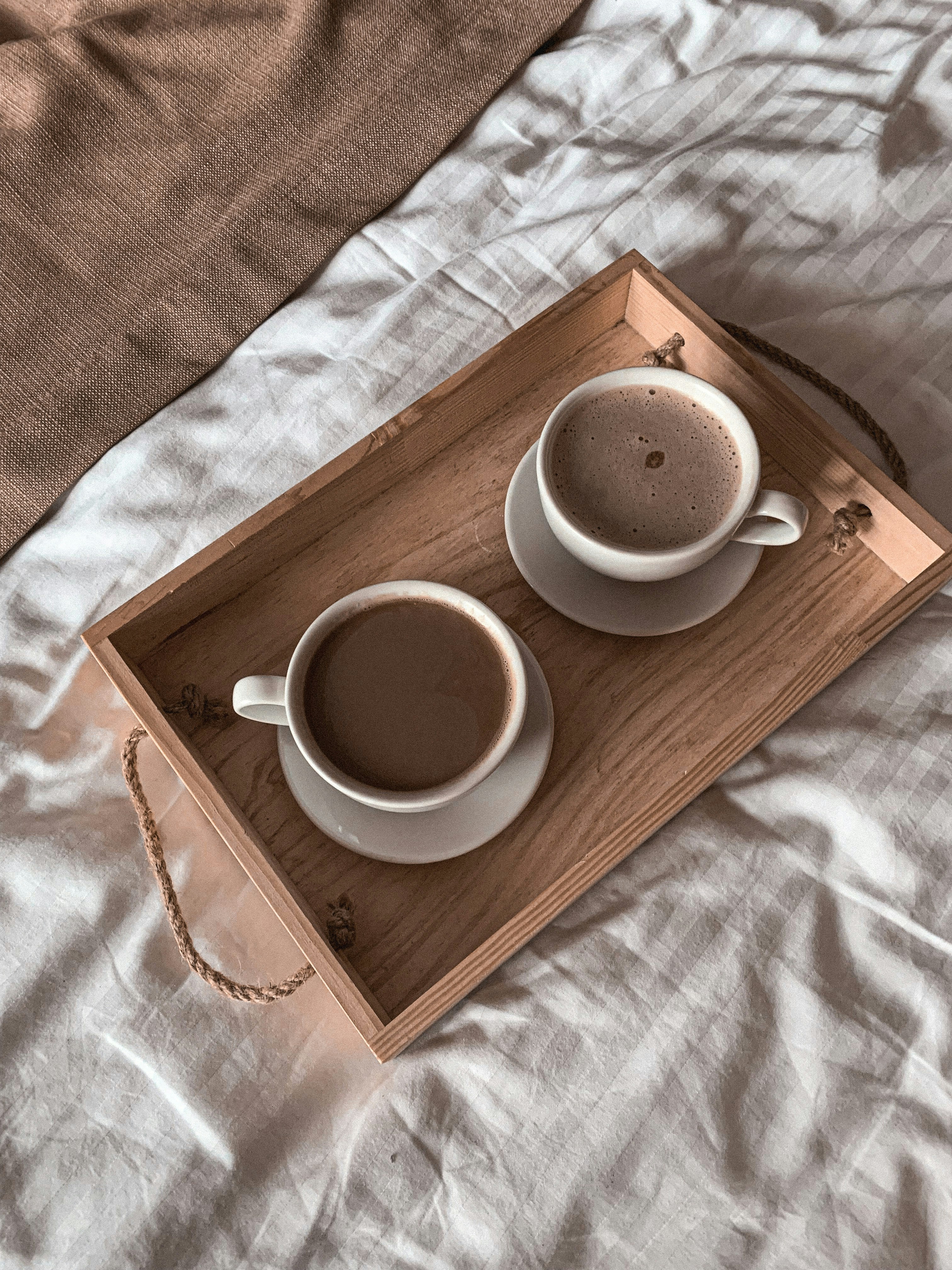white ceramic mug on brown wooden tray