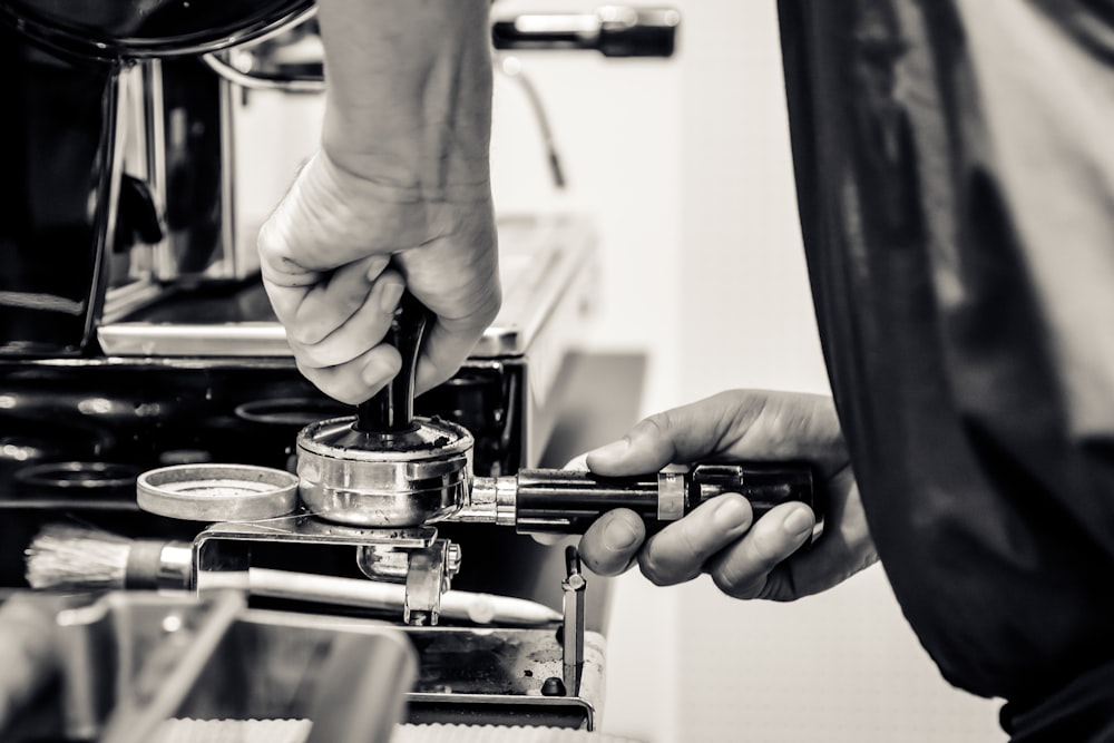 person holding black and silver machine