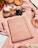 A picnic setup featuring a patterned orange and white blanket. On the blanket are various items including a wooden board with cheese, prosciutto, and grapes. There’s a large notebook or journal, a pen, and a bottle of rosé wine to the side. A halved cantaloupe and a loaf of bread are also present, contributing to a rustic, laid-back vibe.
