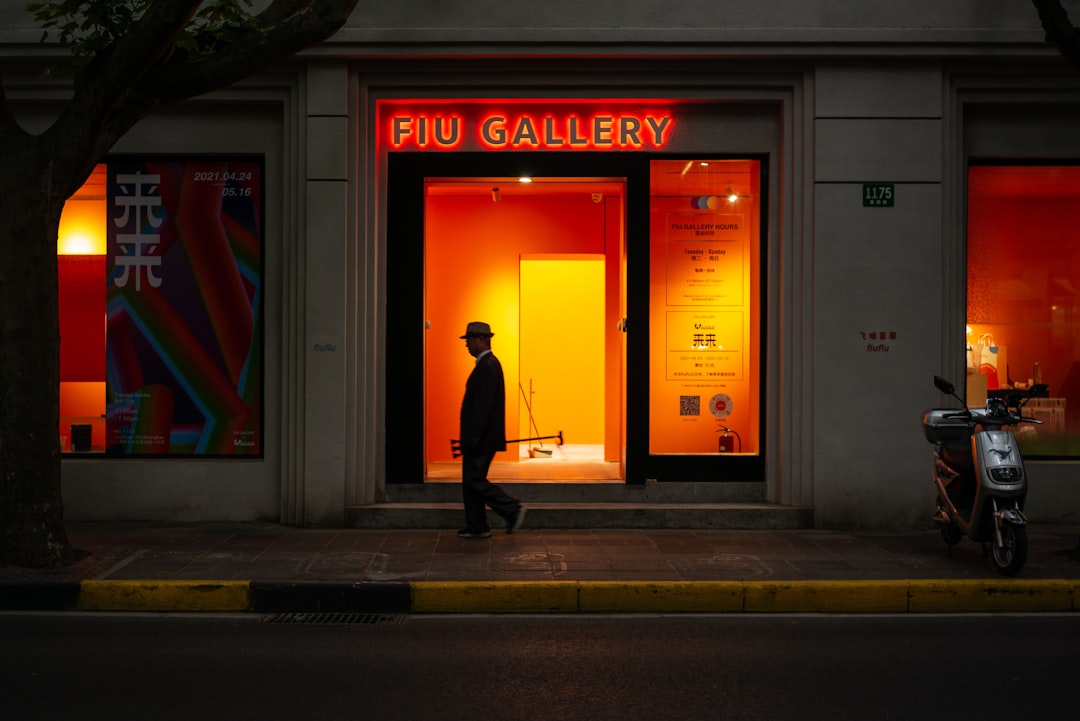 man in black jacket walking on sidewalk during daytime