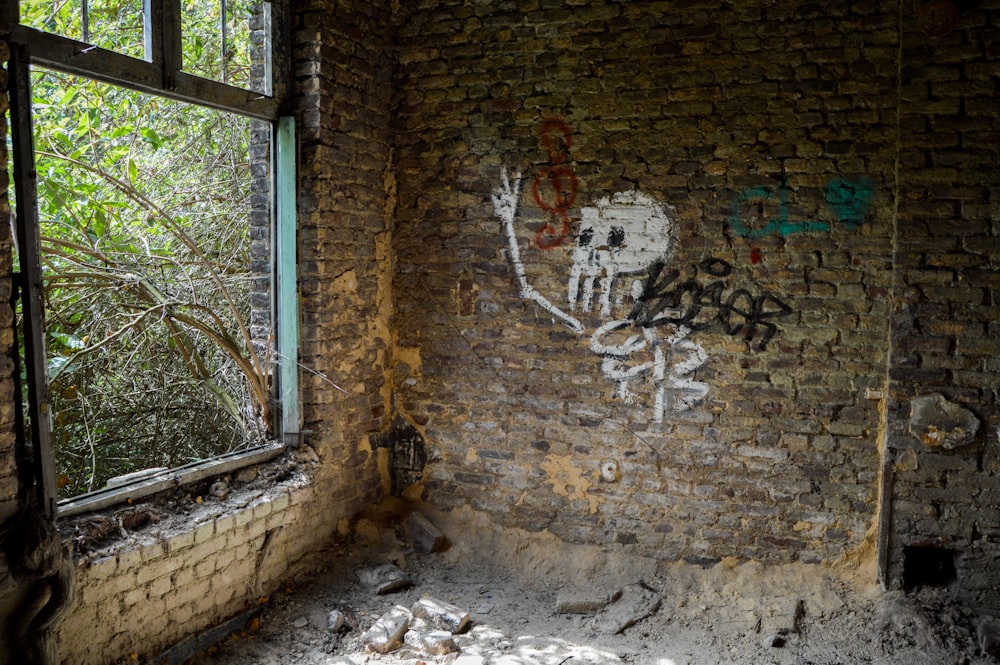 brown brick wall with graffiti