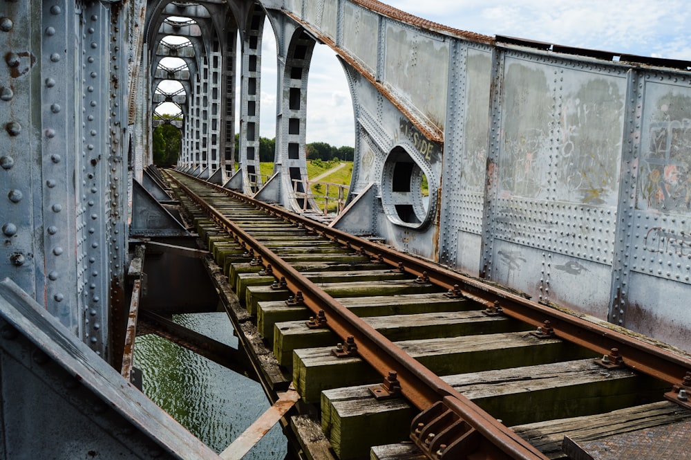 brown wooden bridge over river during daytime