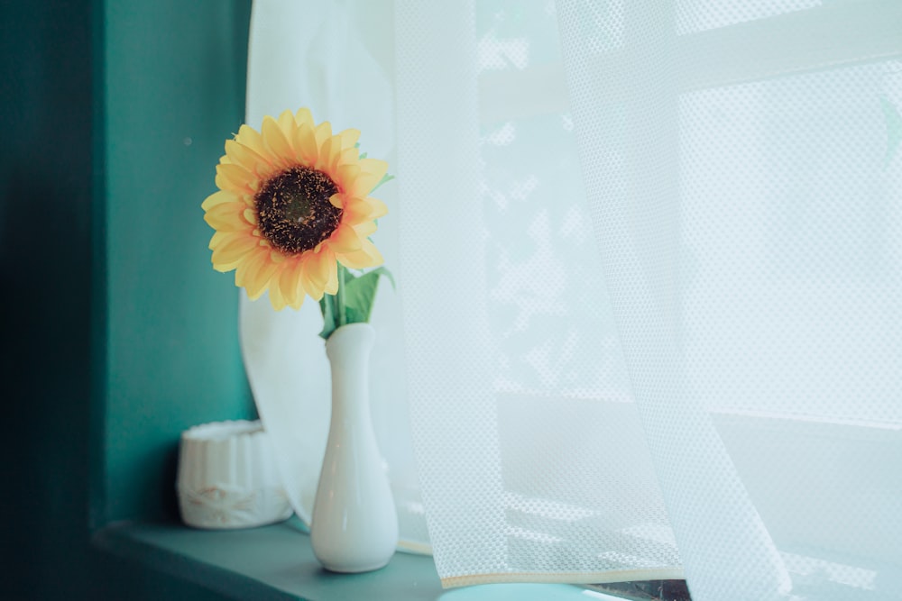 yellow and white flower in white ceramic vase