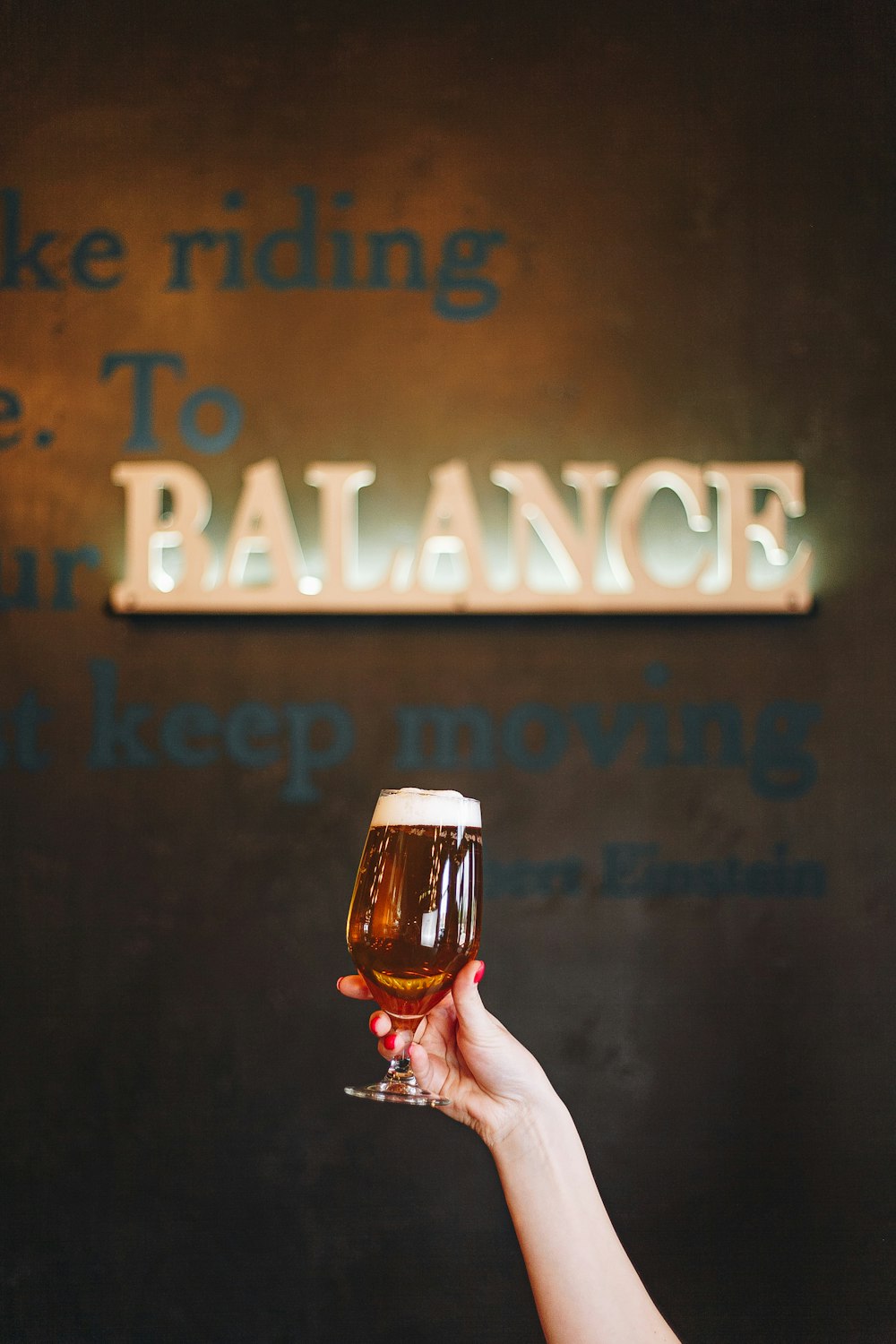 person holding clear drinking glass with beer