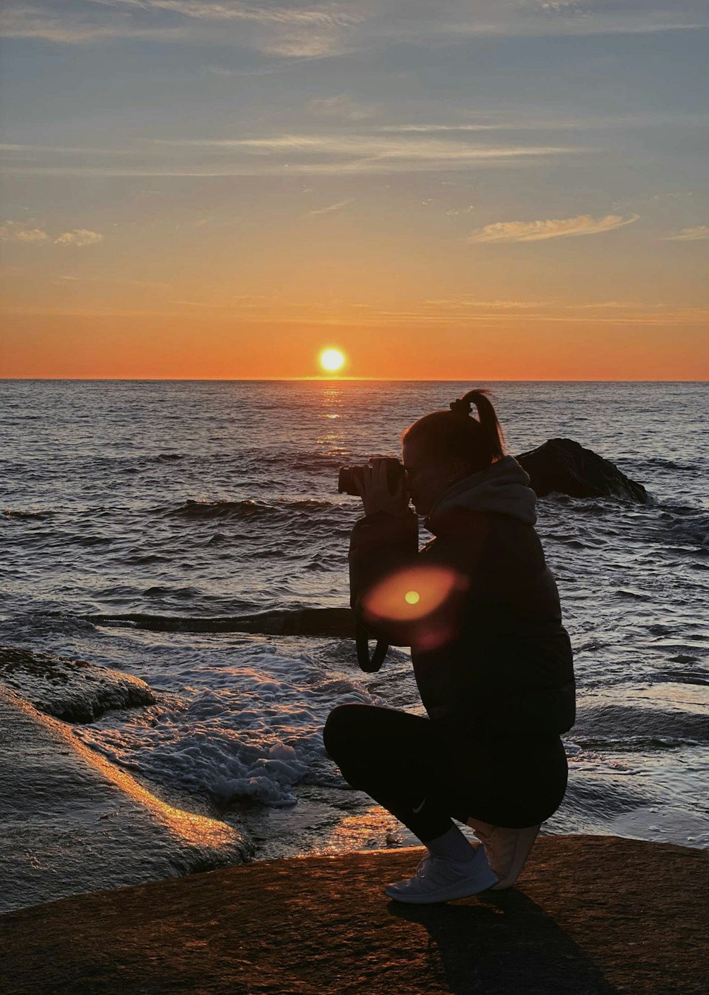 silhouette of man and woman kissing on beach during sunset