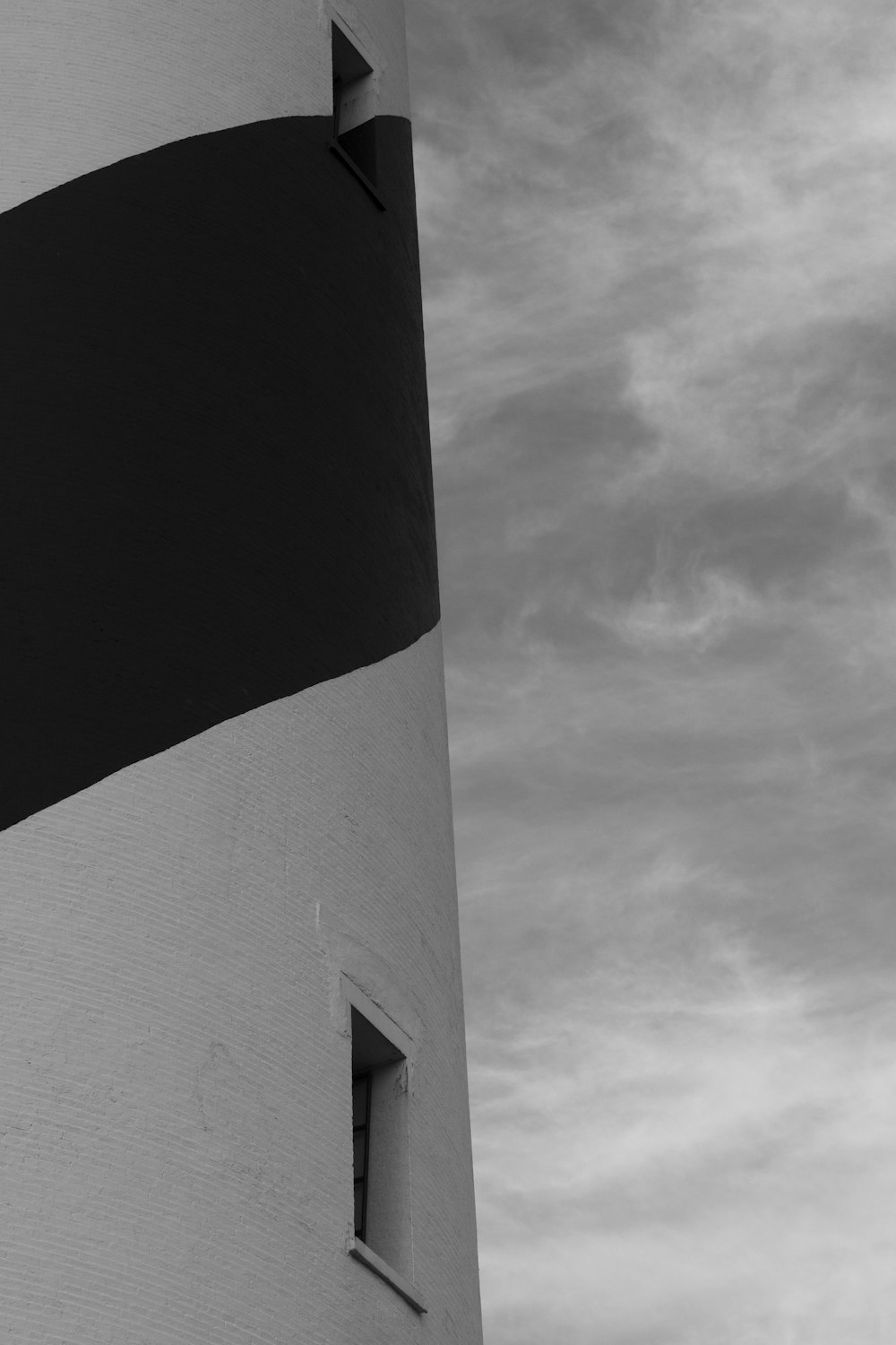 black and white concrete building under cloudy sky